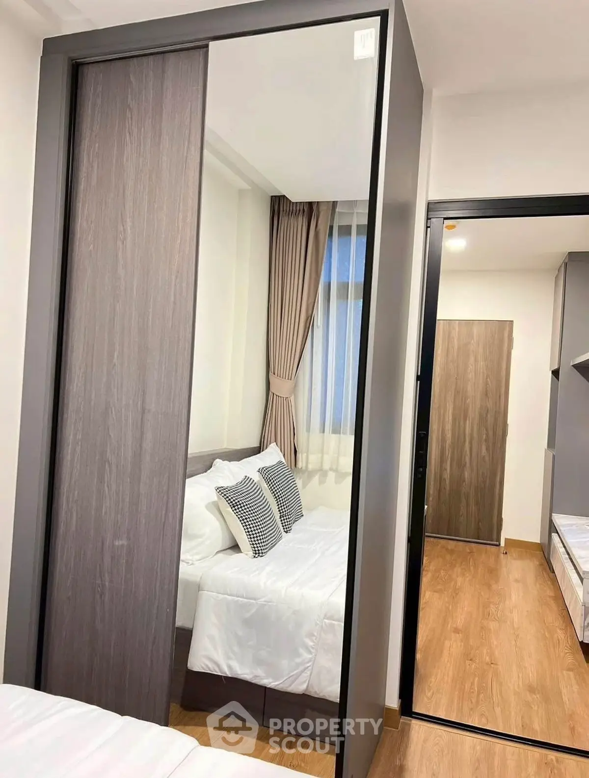 Modern bedroom with sleek sliding wardrobe and cozy bed setup