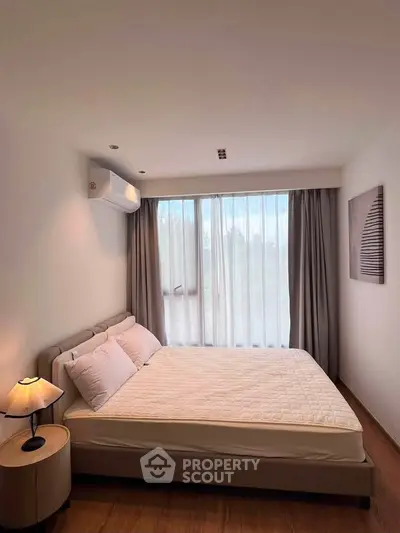Cozy bedroom with large window and modern decor