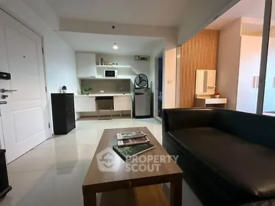 Modern living room with sleek furniture and open kitchen layout
