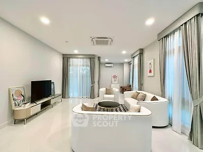 Luxurious modern living room with elegant white furniture and large windows