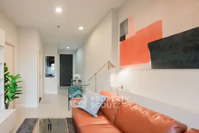 Modern living room with stylish decor and leather sofa in a contemporary apartment.