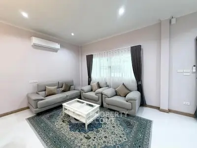Spacious living room with modern gray sofas and elegant decor