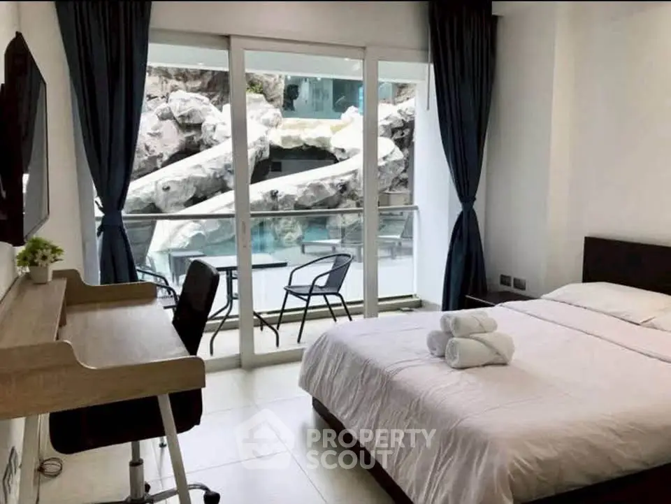 Modern bedroom with pool view and stylish desk setup