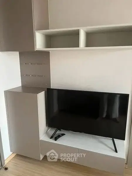 Modern living room with sleek TV setup and stylish storage solutions.