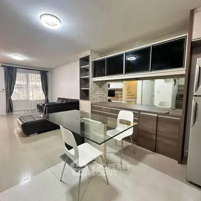 Modern open-plan living room with sleek dining area and stylish furniture