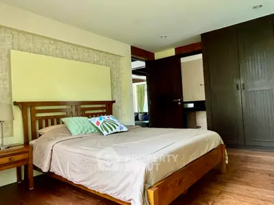 Spacious bedroom with wooden furniture and modern decor