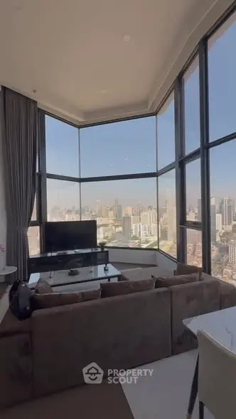 Luxurious corner unit living room with panoramic city views and modern furnishings.