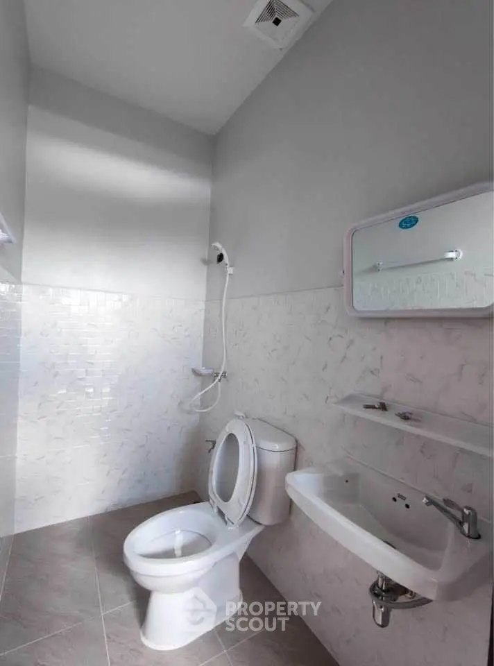 Modern bathroom with sleek fixtures and neutral tiles