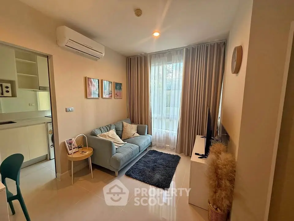 Cozy living room with modern decor and natural light, featuring a comfortable sofa and stylish furnishings.