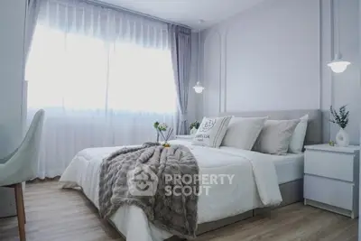 Elegant bedroom with cozy decor and natural light, featuring plush bedding and modern furnishings.