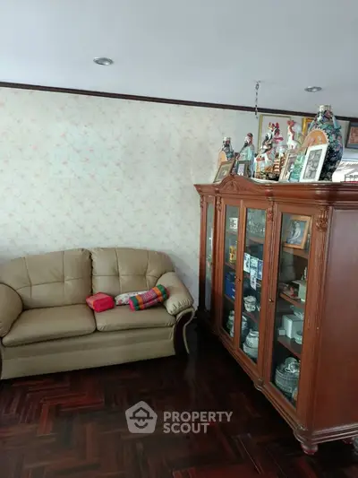 Cozy living room with elegant wooden cabinet and plush sofa