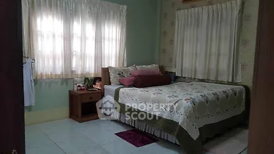 Cozy bedroom with floral quilt and soft lighting