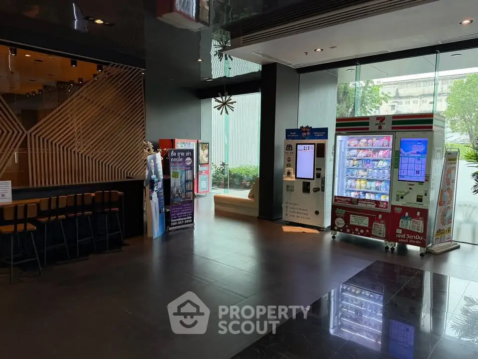 Modern building entrance with vending machines and seating area