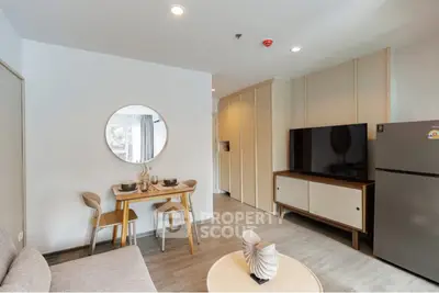 Modern living room with stylish decor and large TV in a cozy apartment
