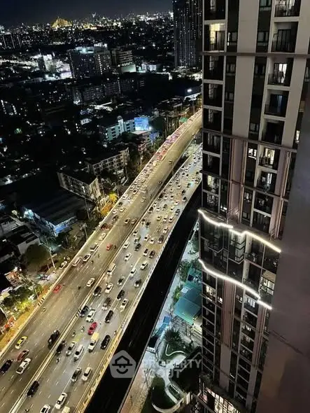 Stunning cityscape night view from high-rise building balcony.