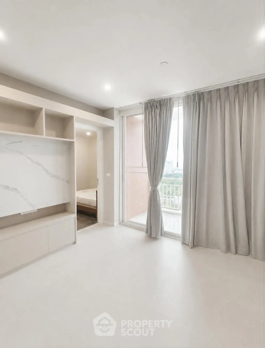 Spacious modern living room with large windows and elegant curtains, offering a bright and airy atmosphere.