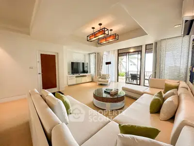 Luxurious living room with modern decor and ocean view balcony, perfect for relaxation and entertainment.