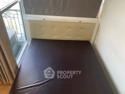 Cozy bedroom with large window and modern bed frame, perfect for natural light lovers.