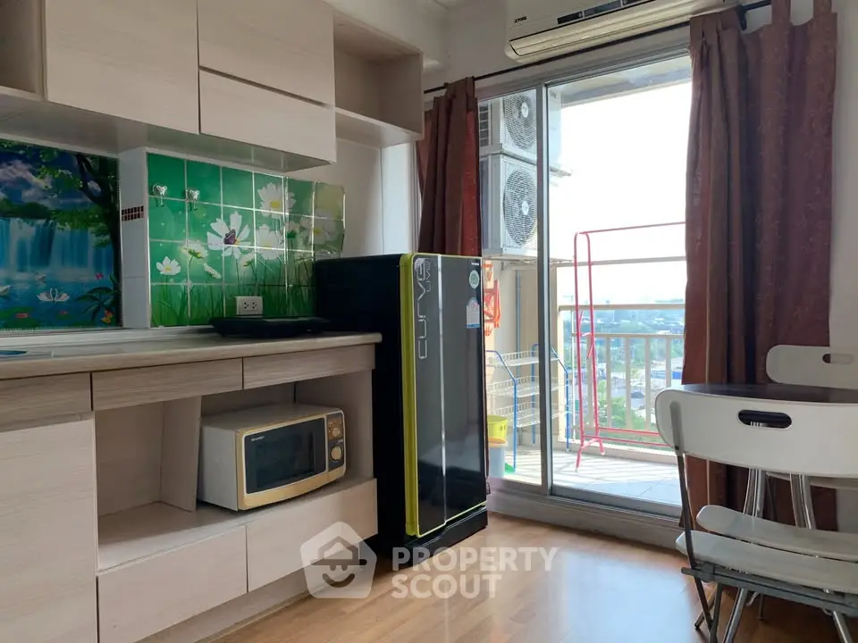 Charming kitchen with balcony view, featuring modern appliances and stylish decor.