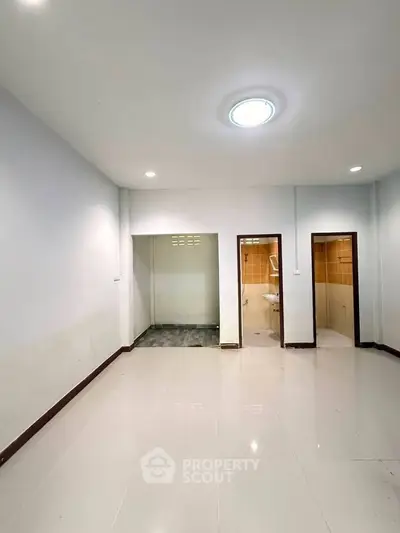 Spacious interior with modern lighting and tiled flooring, ideal for versatile living arrangements.