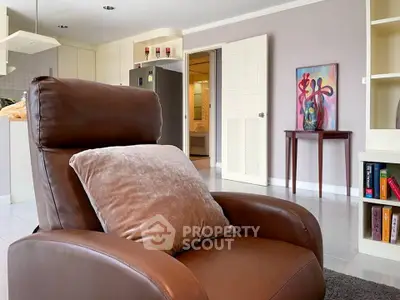 Spacious living room with cozy leather chair and modern decor