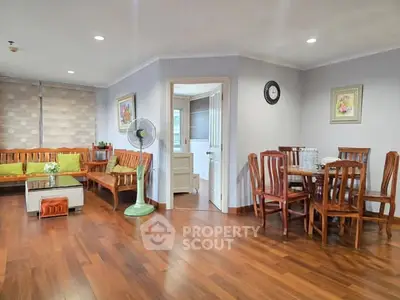 Spacious living room with wooden flooring and elegant dining area