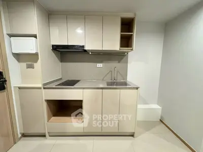 Modern kitchen with sleek cabinetry and integrated appliances in a compact layout.
