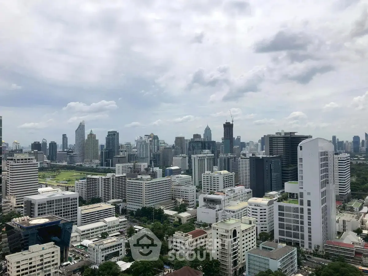 Stunning cityscape view of a modern urban skyline with skyscrapers and lush greenery.
