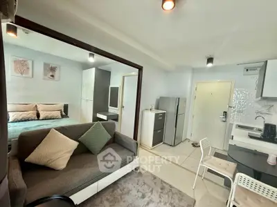 Modern studio apartment with open layout, cozy living area, and stylish kitchen.