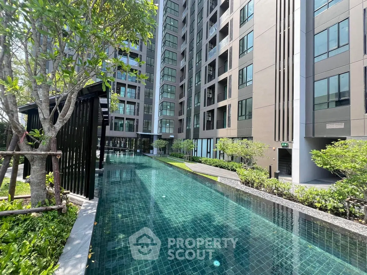 Luxurious condominium with stunning pool and lush greenery, perfect for modern living.