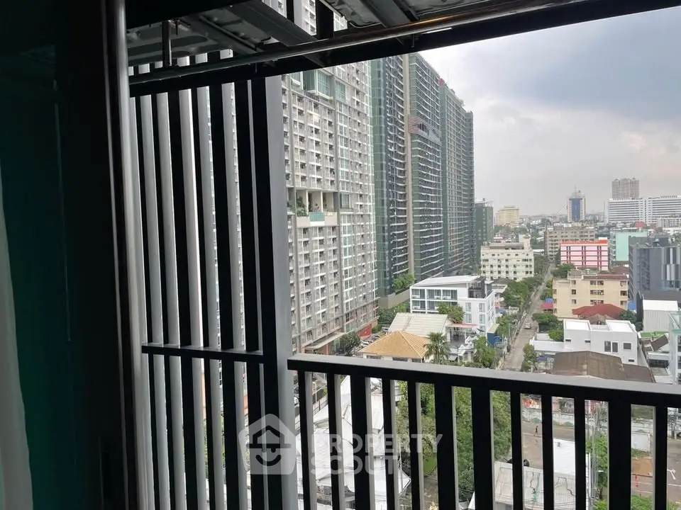 Stunning cityscape view from a high-rise balcony with modern architectural design.