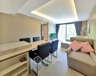 Spacious modern living room with dining area and large window view