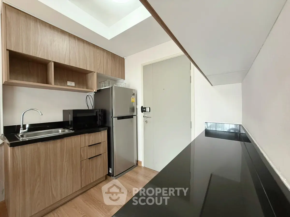 Modern kitchen with sleek wooden cabinets and stainless steel appliances