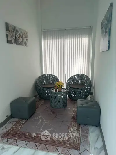Cozy modern living room with stylish wicker chairs and elegant decor, perfect for relaxation and entertaining.