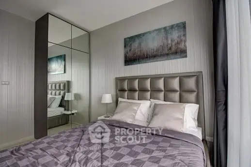 Modern bedroom with elegant decor and mirrored wardrobe