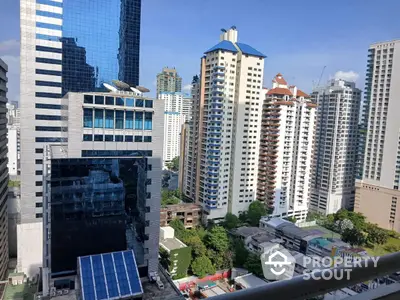 Stunning cityscape view from a high-rise balcony showcasing modern skyscrapers and lush greenery.