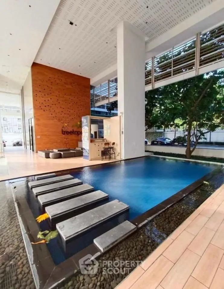 Luxurious indoor pool area with modern design and natural lighting in a high-end residential building.