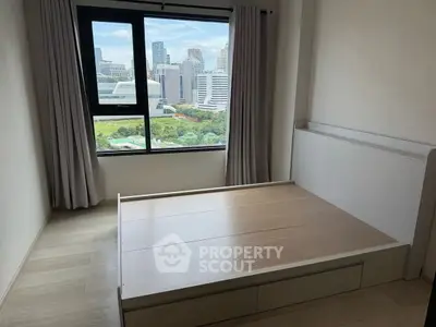 Modern bedroom with city view and large window, minimalist design