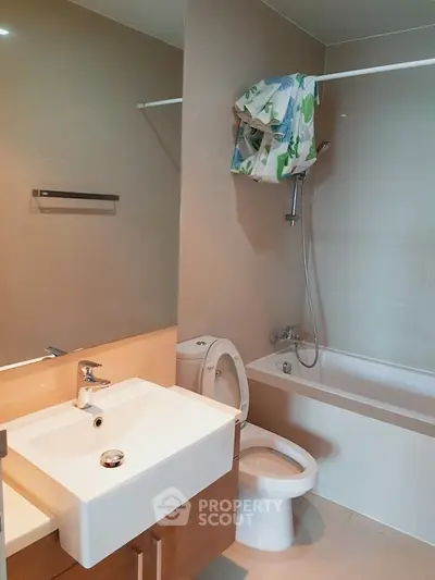 Modern bathroom with bathtub and sleek fixtures in a contemporary apartment.