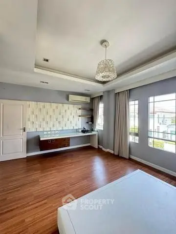 Spacious modern living room with wooden flooring and large windows