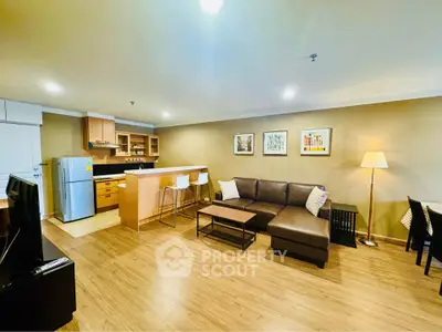 Spacious open-layout living room with modern kitchen and cozy seating area