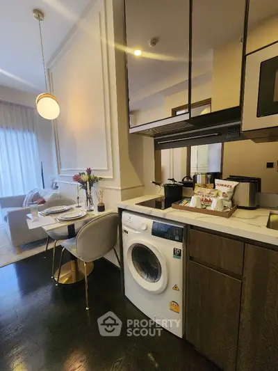 Modern apartment interior with washing machine and cozy dining area