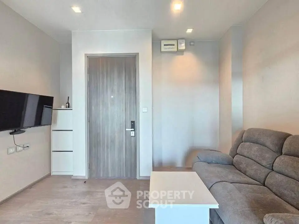 Modern living room with sleek furniture and wall-mounted TV, perfect for contemporary living.
