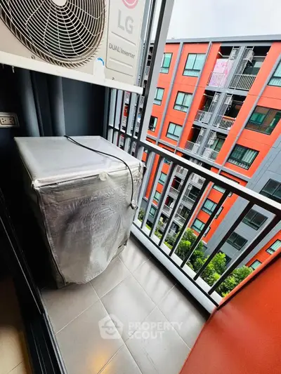 Modern balcony with washing machine and view of colorful building