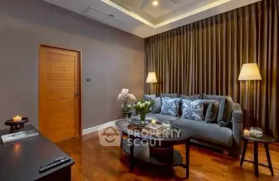 Elegant living room with cozy sofa, stylish decor, and warm lighting, perfect for relaxation and entertaining.