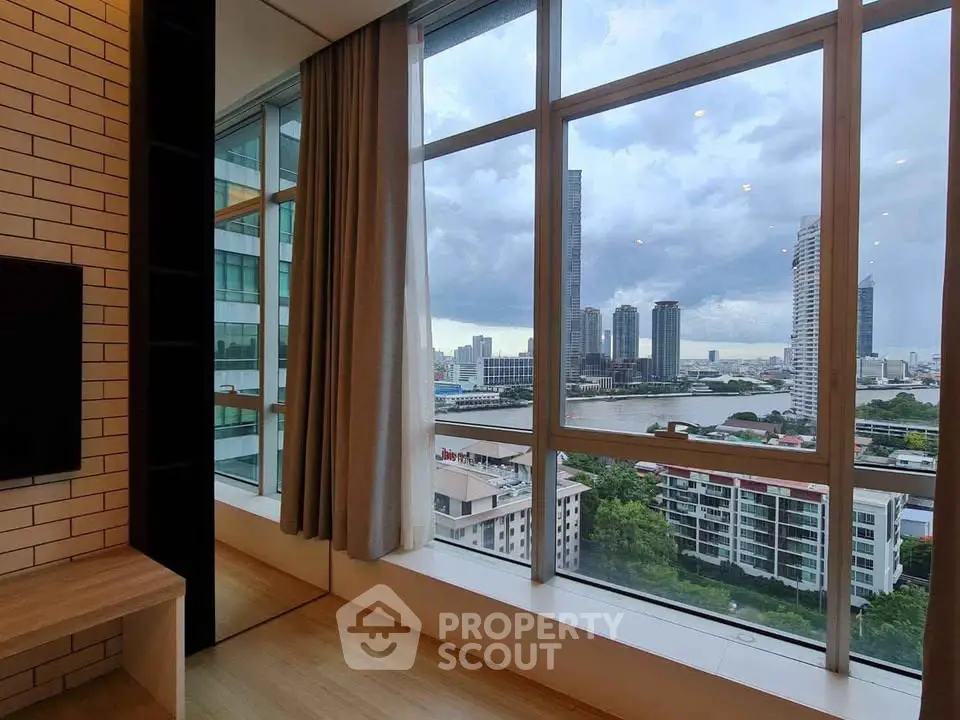 Stunning high-rise apartment with panoramic city and river views, featuring floor-to-ceiling windows and modern design.