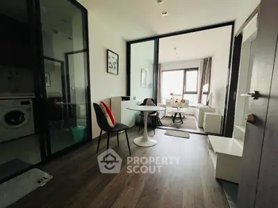 Modern apartment interior with stylish dining area and cozy living space, featuring sleek furniture and natural light.