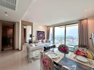 Luxurious living room with stunning ocean view, modern furniture, and elegant dining area in a high-rise apartment.