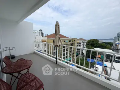 Spacious balcony with city and ocean views, perfect for relaxation.