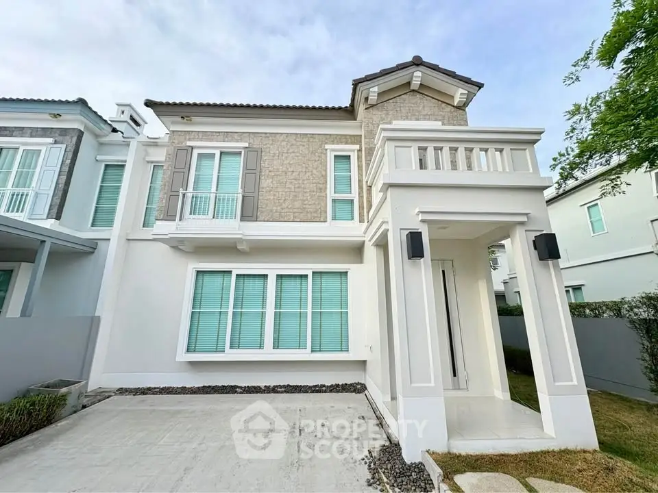 Modern two-story house with elegant facade and spacious driveway in a serene neighborhood.